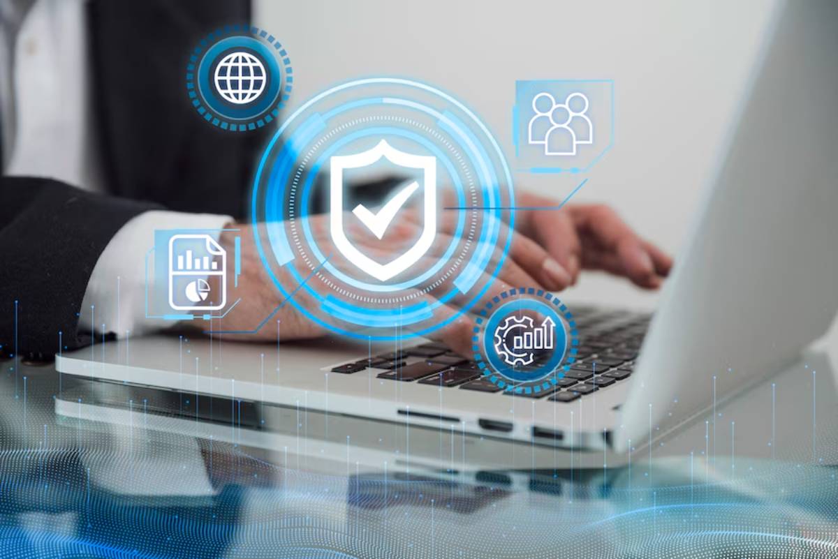 A person typing on a laptop, surrounded by digital icons representing security, analytics, and connectivity.