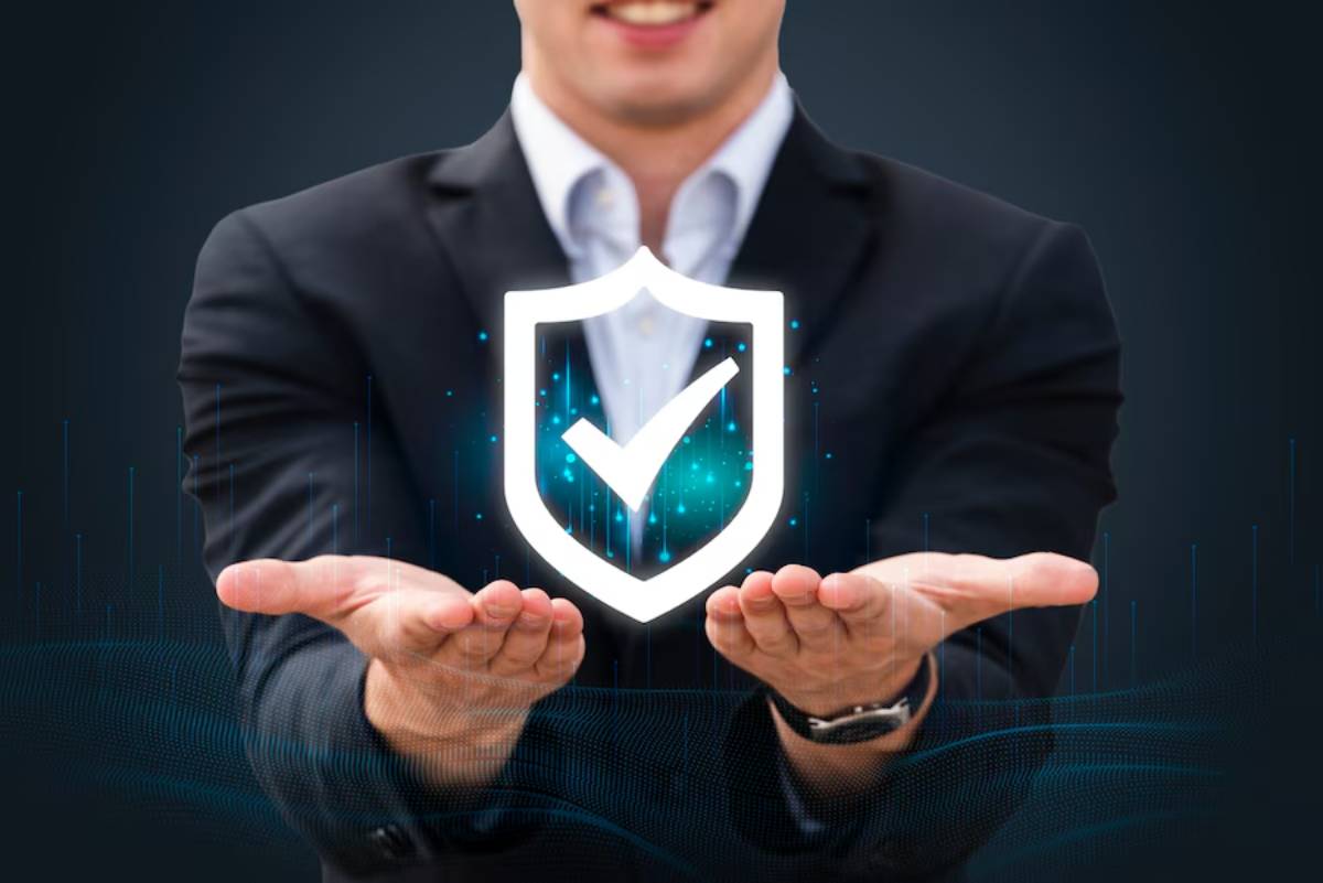A businessman in a suit holds a glowing shield with a checkmark, symbolizing security and trust, against a dark digital backdrop.