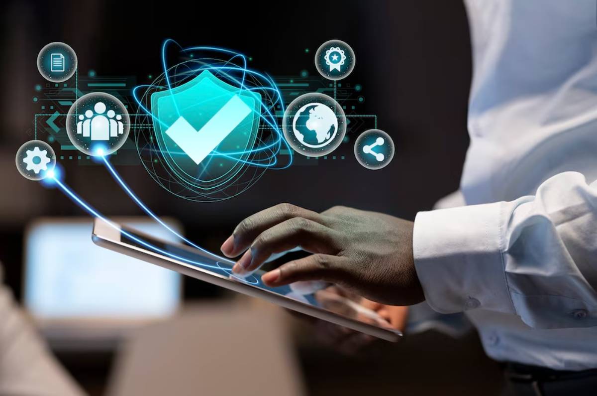 A person in a white shirt interacts with a tablet, surrounded by digital security icons, representing data protection and connectivity.