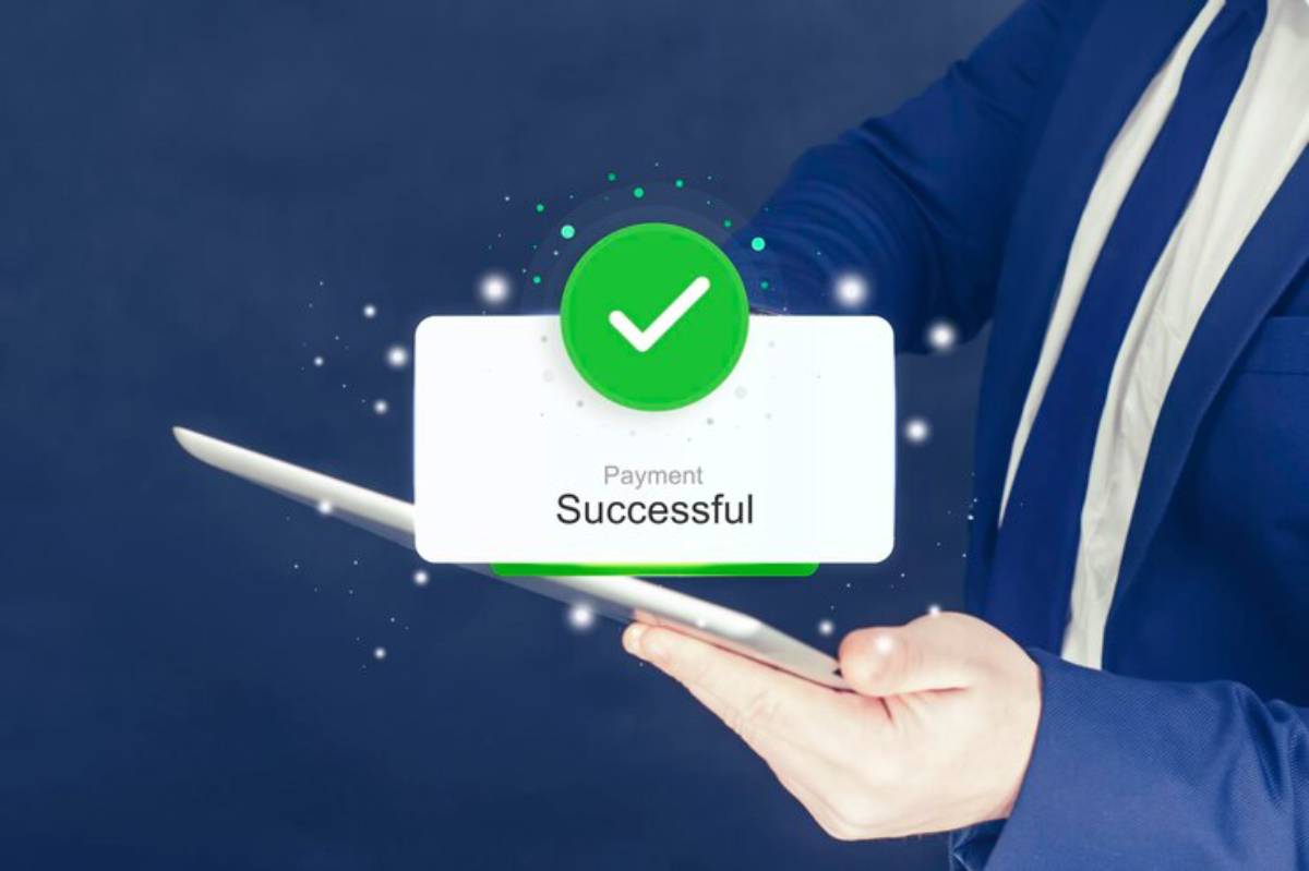 A person in a suit holds a tablet displaying a green Payment Successful notification with a checkmark.